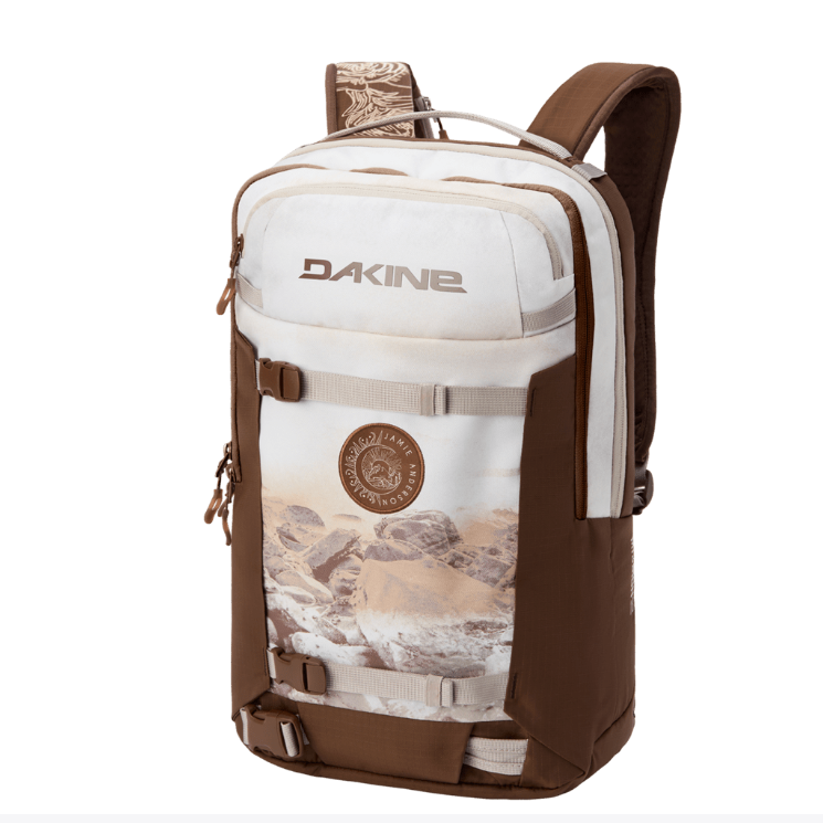 Brown and white backpack with a desert landscape design and Dakine branding on a white background.